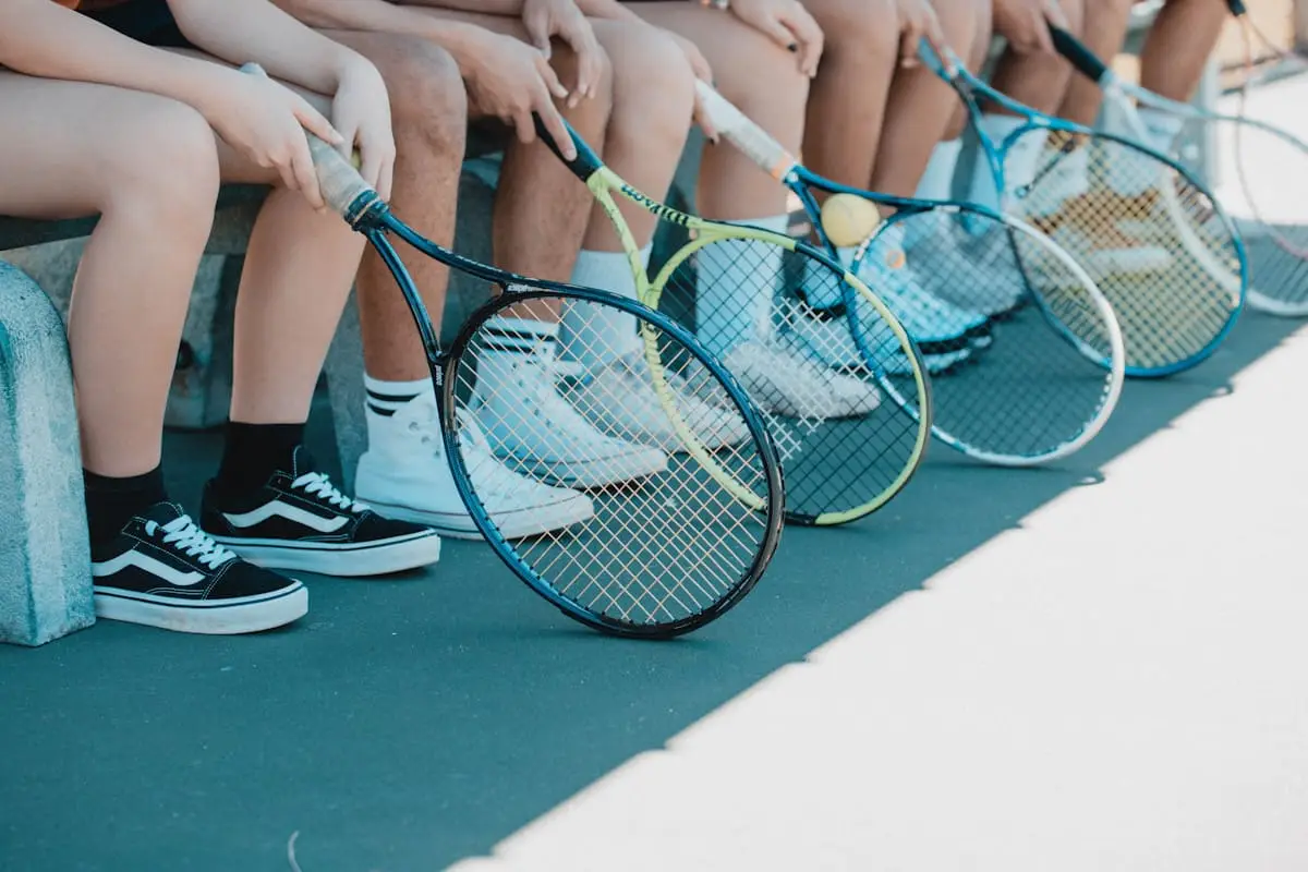 Teniszütők és sportcipők a pálya szélén